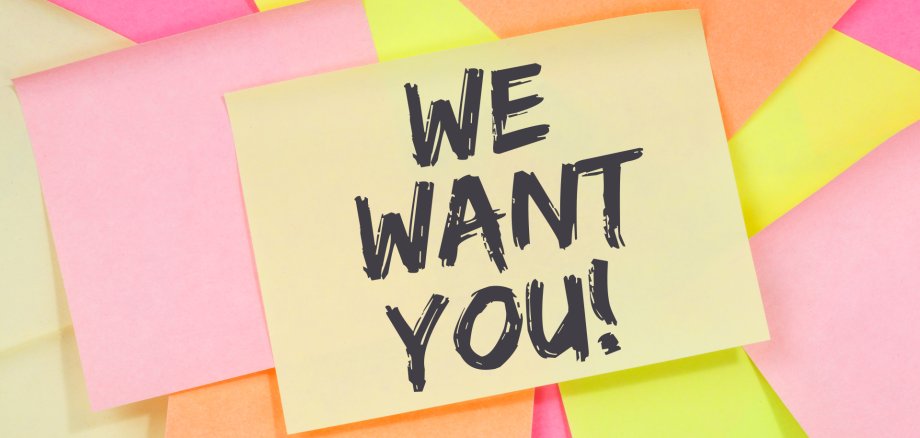 Diversi foglietti adesivi colorati, tra cui uno giallo con il testo "WE WANT YOU!" a caratteri neri.