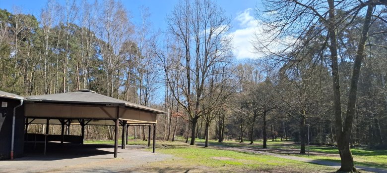 Waldfreizeitanlage Dudenhofen Links im Bild ist das überdachte Holzgebäude der Waldfreizeitanlage, in der Mitte und rechts sind Wiese und Wald mit Blick zur Gänsbrüh in Dudenhofen