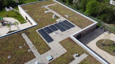 Flachdach Grünbepflanztes Flachdach eines Gebäudes mit Solaranlagen