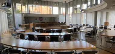 Stadtverordnetensaal Runder Sitzungssaal mit Holz- und Metallstühlen und großen Fenstern im Stadtverordnetensaal des Rathauses in Jügesheim